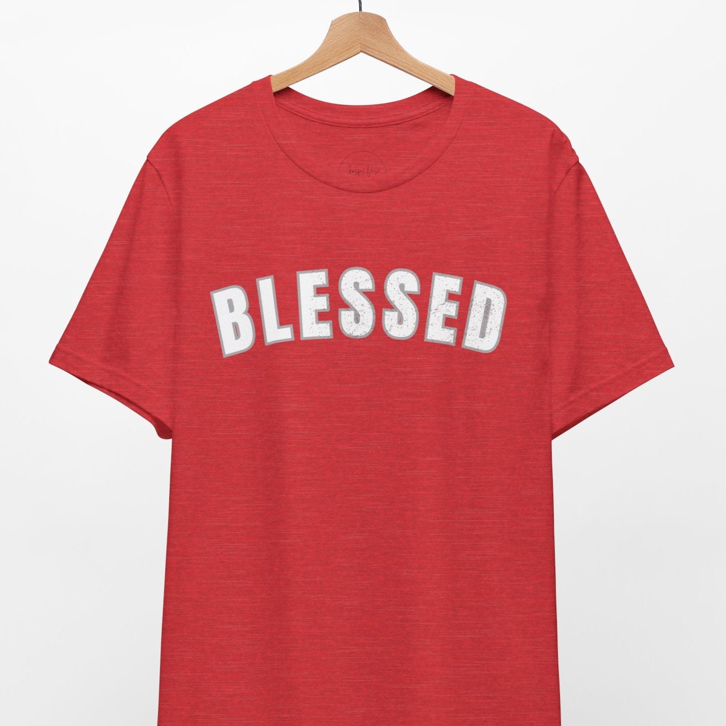 Red t-shirt with 'BLESSED' text on a hanger against a white background