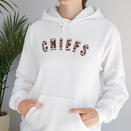 Person wearing a white hoodie with 'CHIEFS' printed with a football type font, standing against a plain background.