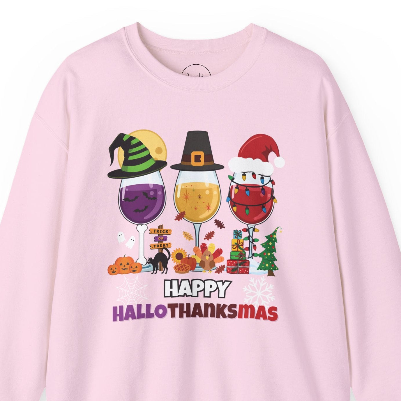 Pink sweatshirt with 'Happy HalloThanksMas' design featuring Halloween and Thanksgiving elements on a white background.