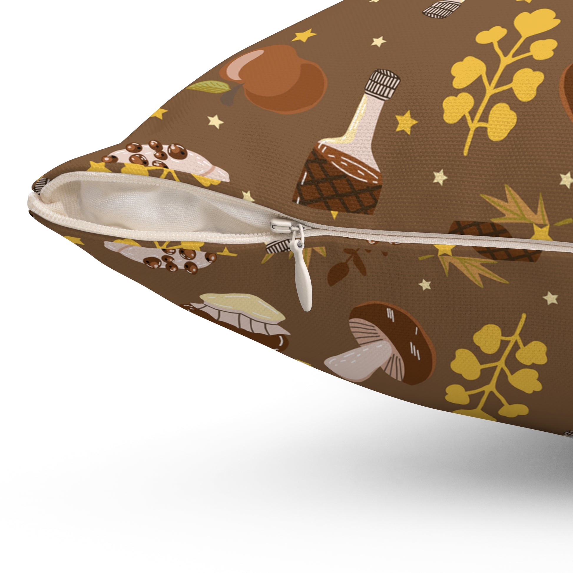 Close-up of brown fall pillow showing white zipper and detailed autumn dessert and leaf print design.