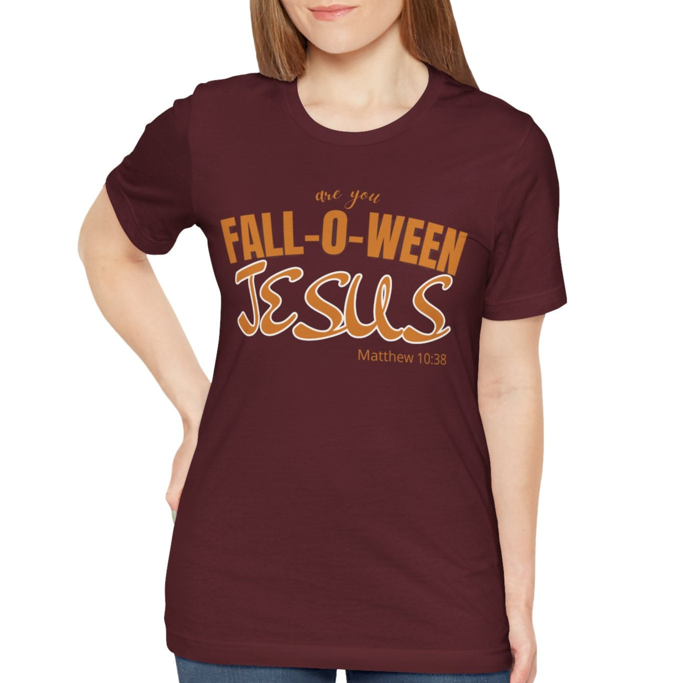 Woman wearing a maroon t-shirt with 'Fall-O-Ween Jesus' text on a white background