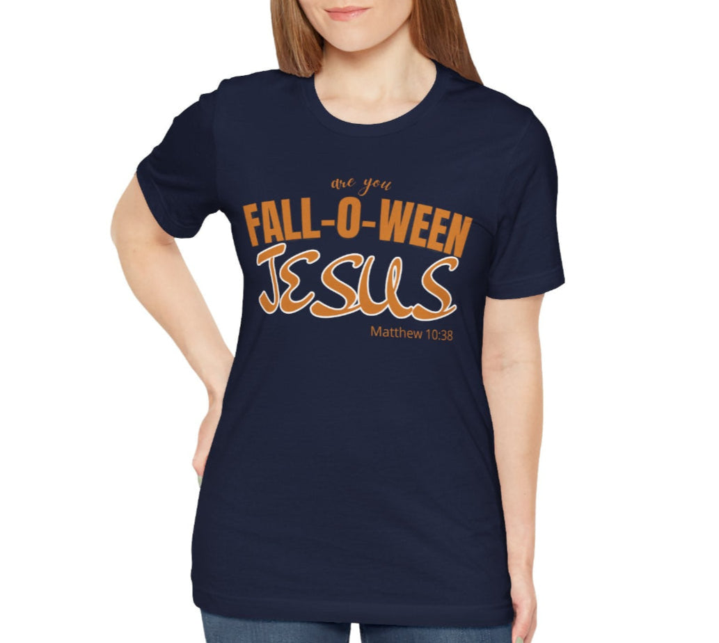 Woman wearing a navy blue t-shirt with 'Fall-o-Ween Jesus' text on a white background