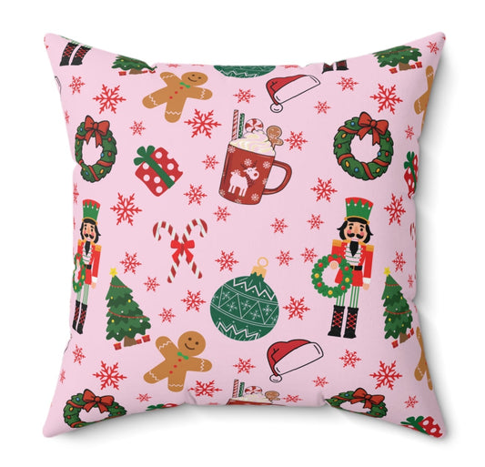 Decorative pillow with Christmas-themed pattern on a pink background