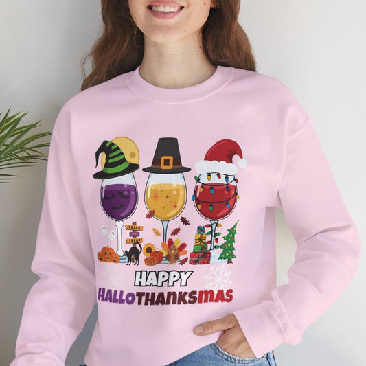 Person wearing a pink sweatshirt with 'Happy Hall-O-THANKSMAZ' design, sitting on a white surface with a plant in the background.