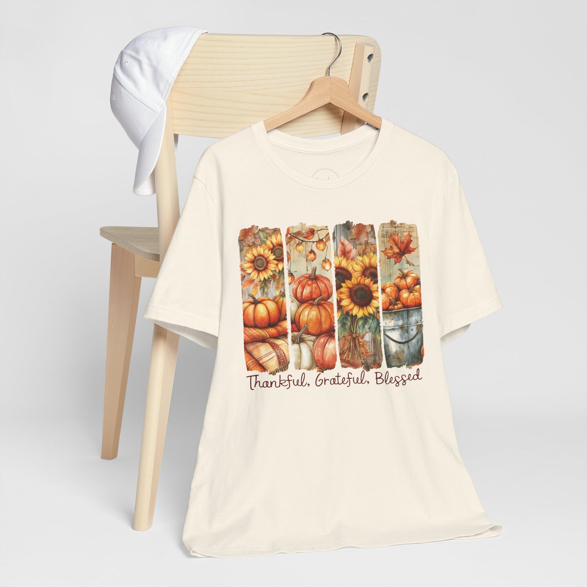 Beige t-shirt with autumn-themed design and text on a white background