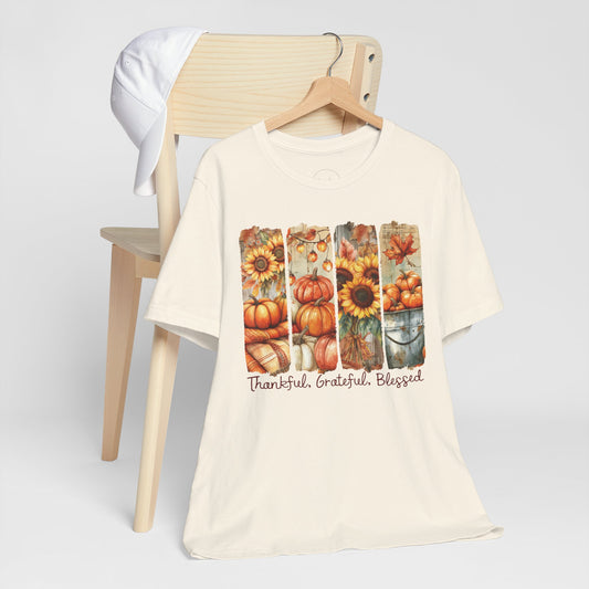 Beige t-shirt with autumn-themed design and text on a white background