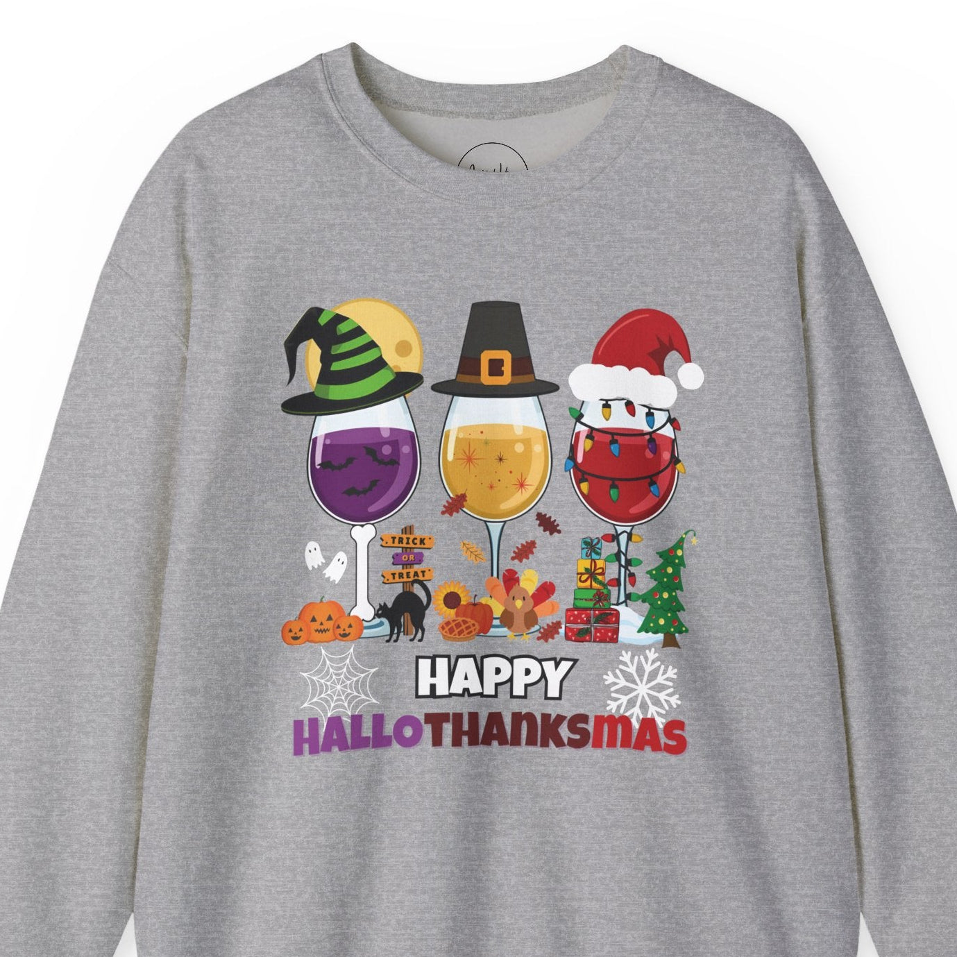 Gray sweatshirt with 'Happy HalloThanksMas' design featuring wine glasses and holiday elements on a white background.
