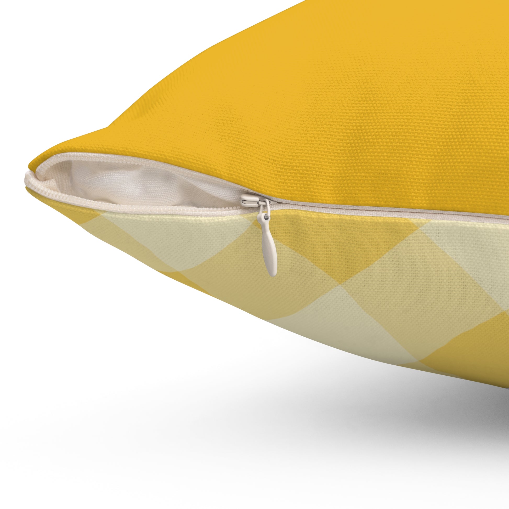 Close-up of yellow gingham pillow with white zipper, durable fabric design for farmhouse home decor.