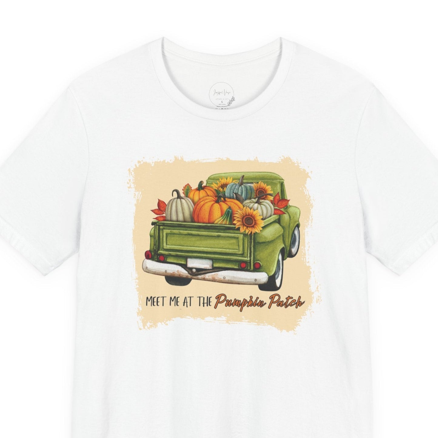 White t-shirt with a graphic of a green truck carrying pumpkins and flowers, with text 'Meet me at the Pumpkin Patch' on a white background.