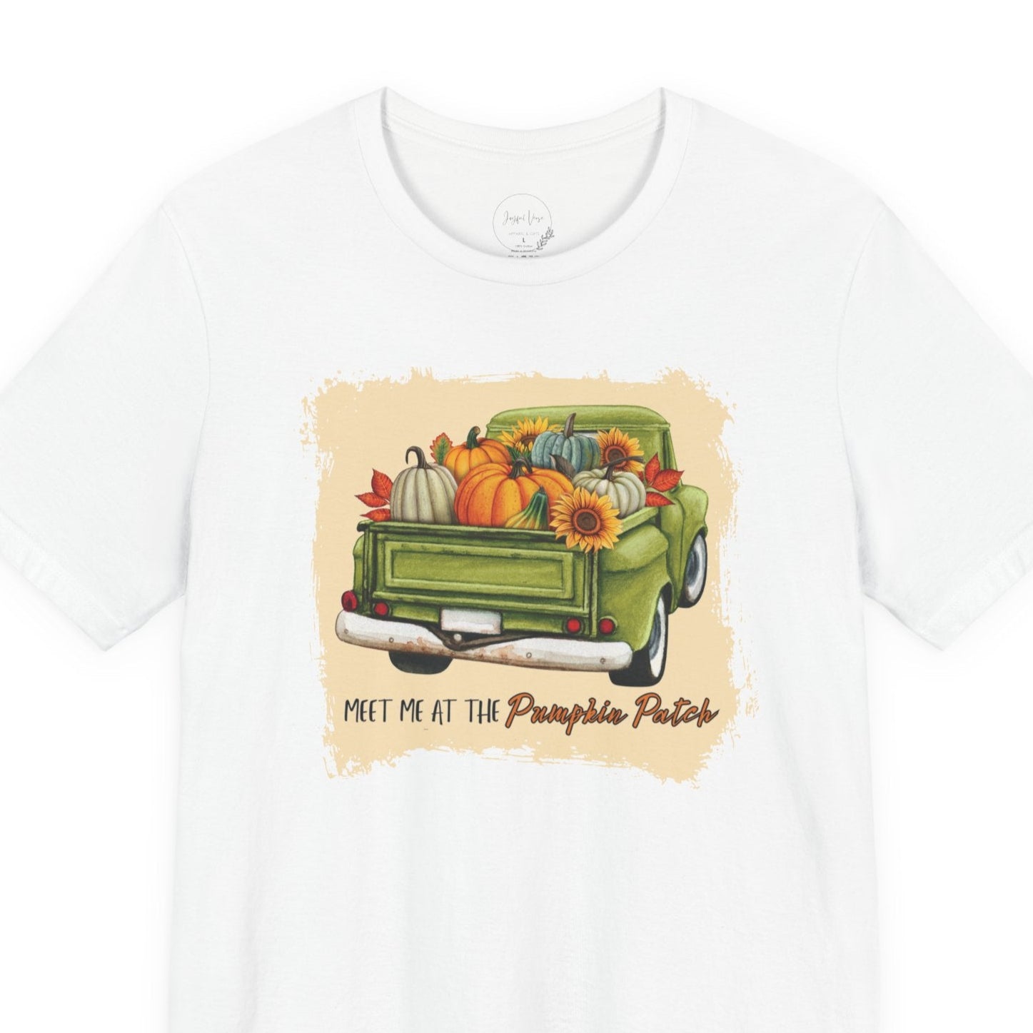 White t-shirt with a graphic of a green truck carrying pumpkins and flowers, with text 'Meet me at the Pumpkin Patch' on a white background.