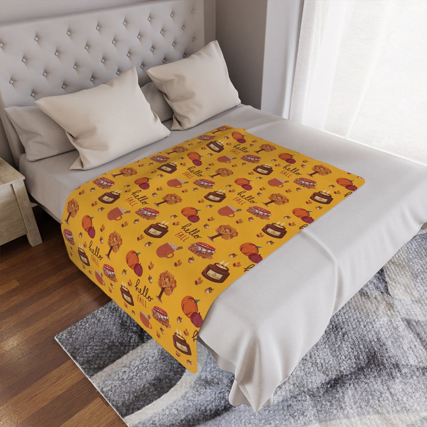 Yellow patterned minky blanket on a bed in a bedroom setting