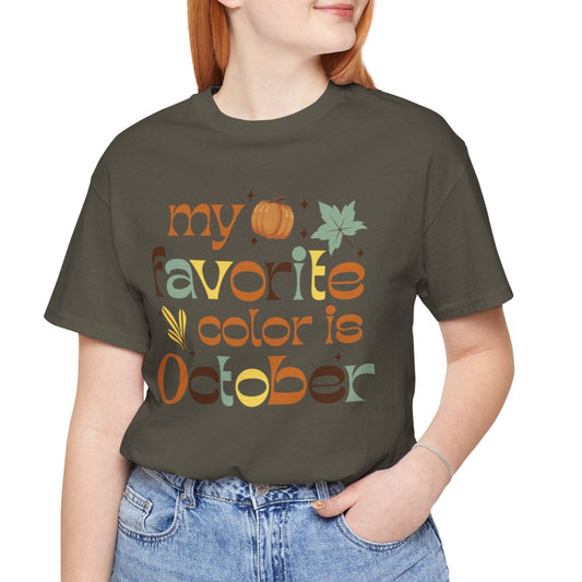 Person wearing a t-shirt with 'my favorite color is October' text and graphics.