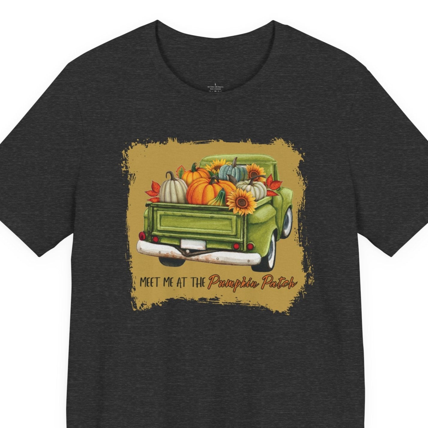Black t-shirt with a graphic of a green truck carrying pumpkins and fall decorations on a white background.