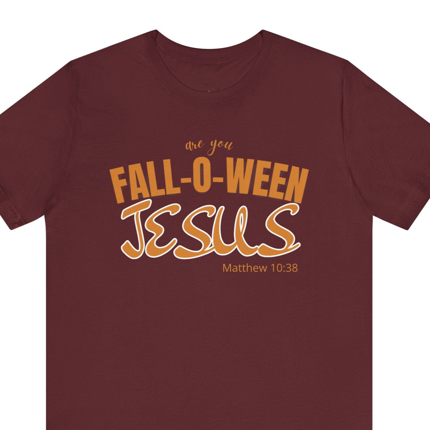 Maroon t-shirt with 'Fall-O-Ween Jesus' text in orange on a white background