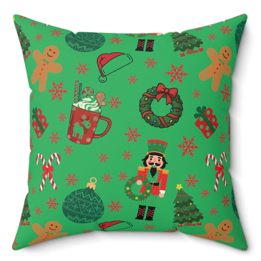Green pillow with Christmas-themed pattern on a white background