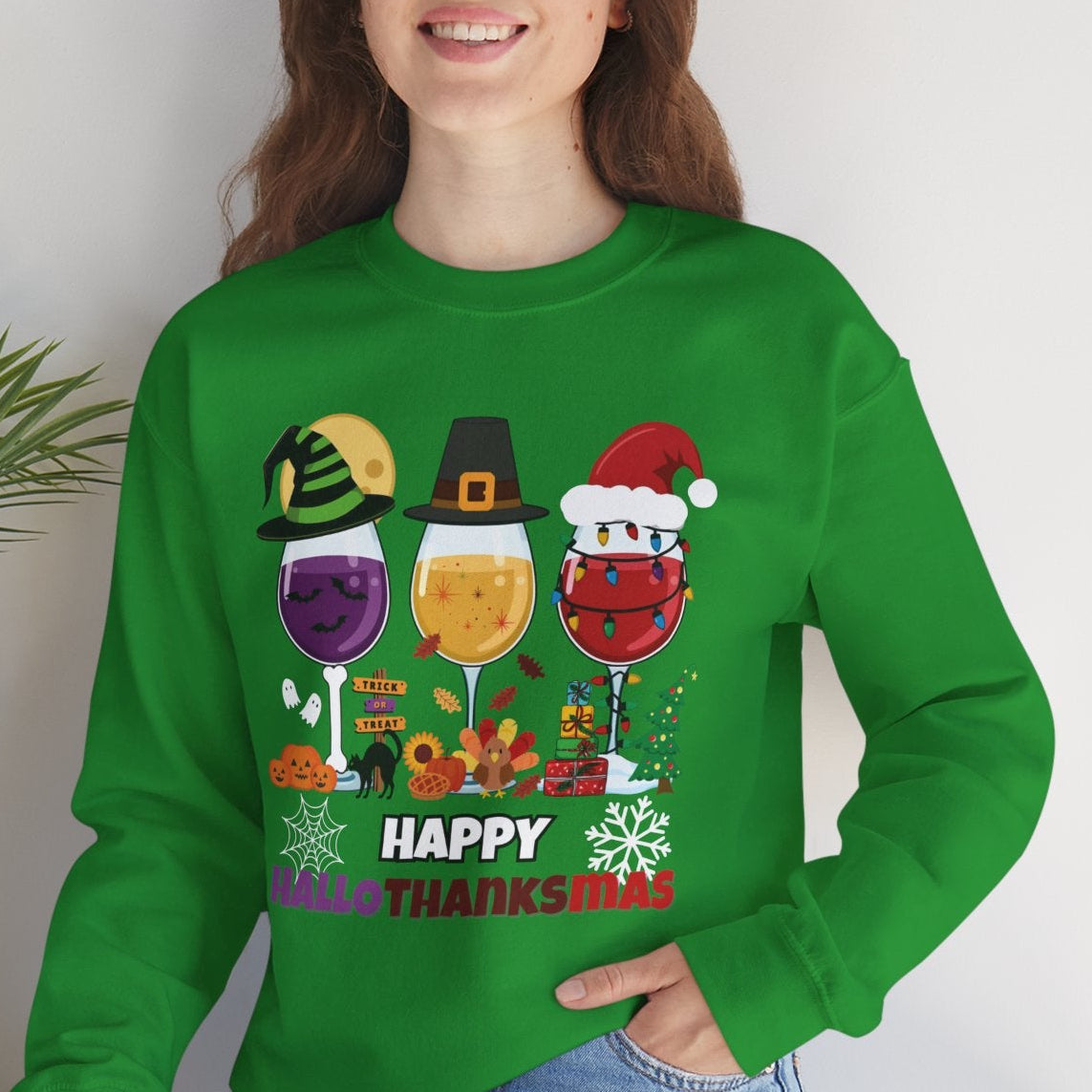 Person wearing a green sweatshirt with a festive design, sitting on a white surface with a plant in the background.