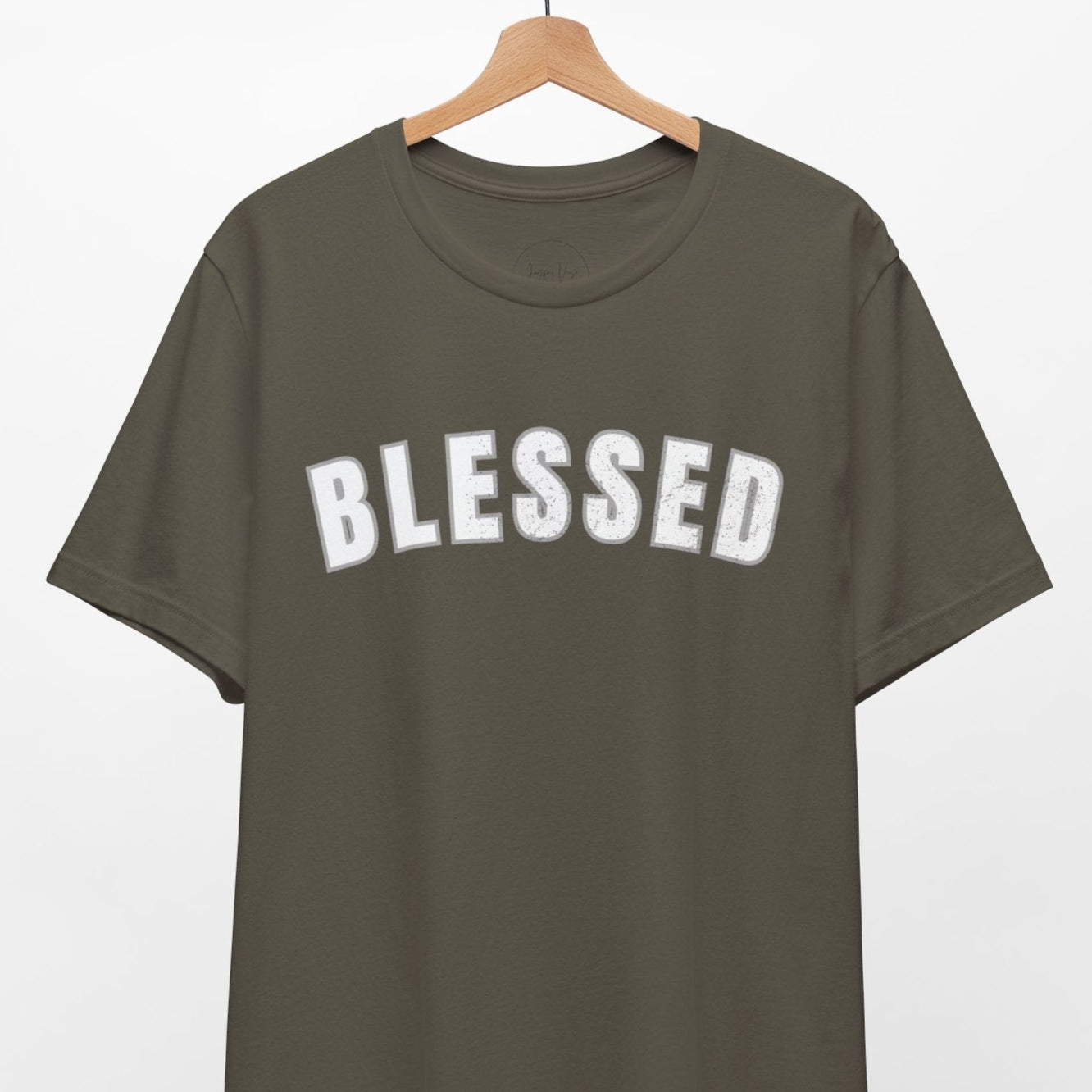 Green t-shirt with 'BLESSED' text on a hanger against a white background