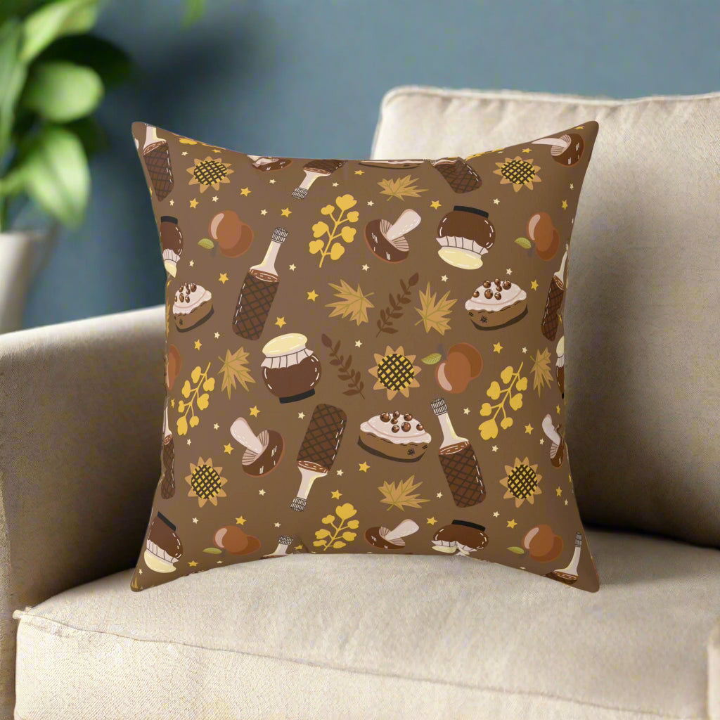 Brown autumn pillow with cozy fall treats and leaves pattern on beige sofa for seasonal home decor.