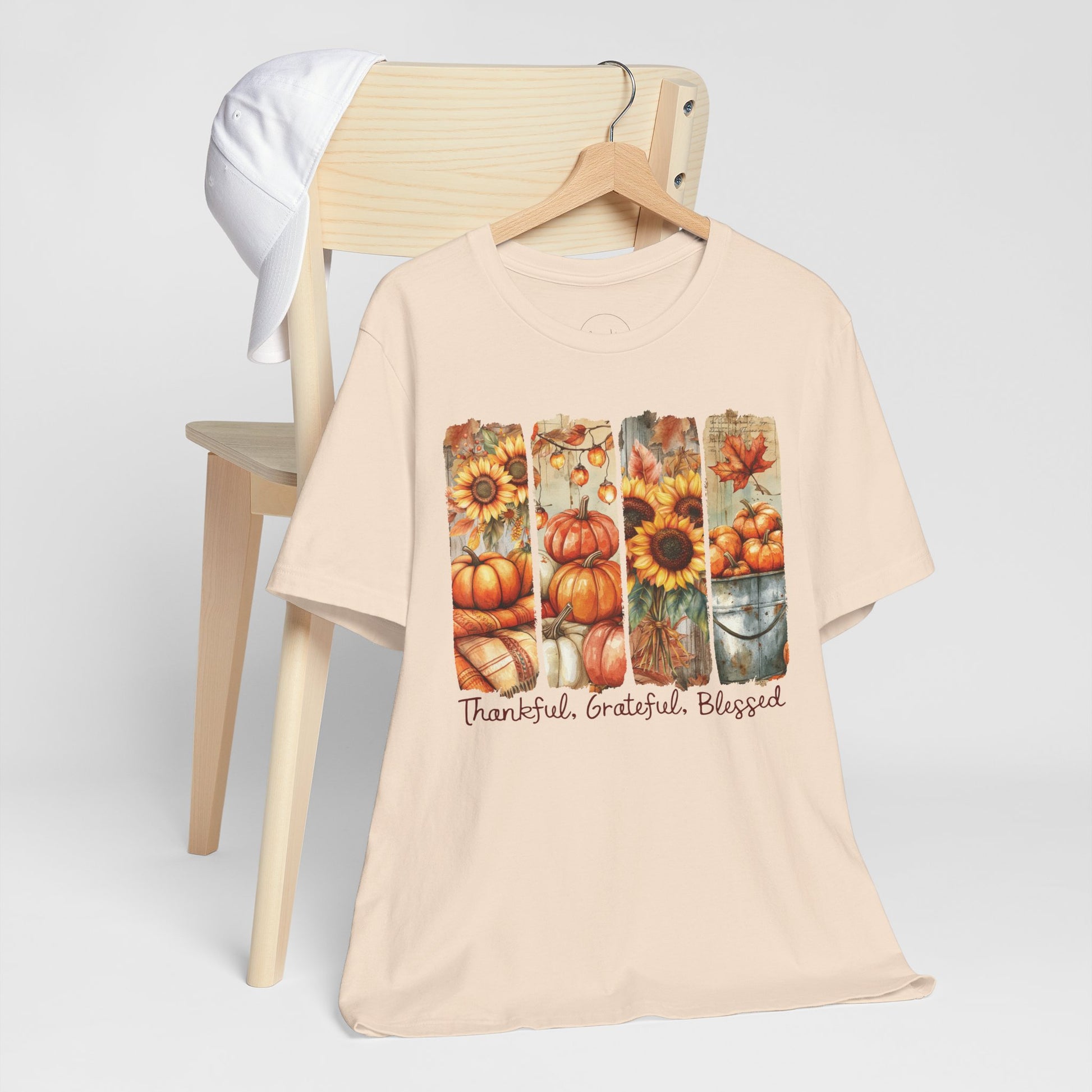 Beige t-shirt with autumn-themed design and text on a white background