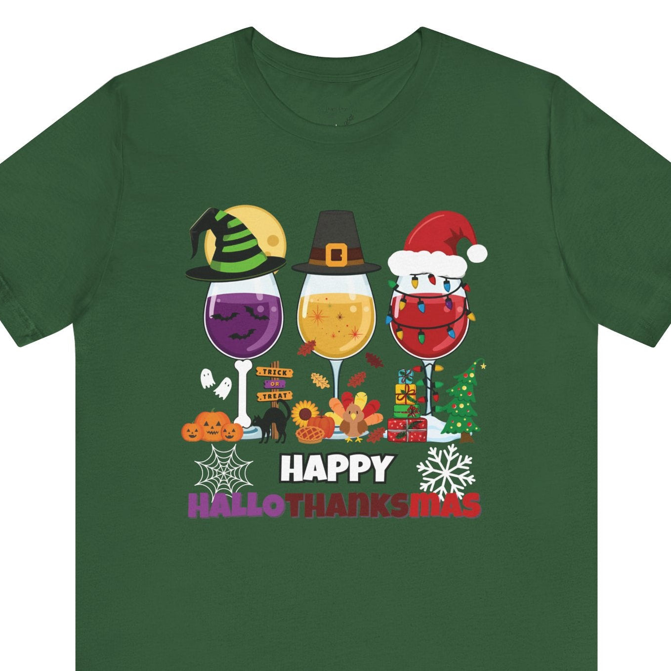 Green t-shirt with 'Happy HalloThanksMas' design featuring wine glasses and holiday-themed graphics on a white background.