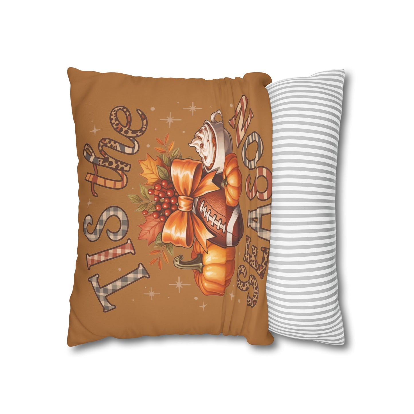 Decorative pillow with autumn-themed design and striped pillow next to it on a white background