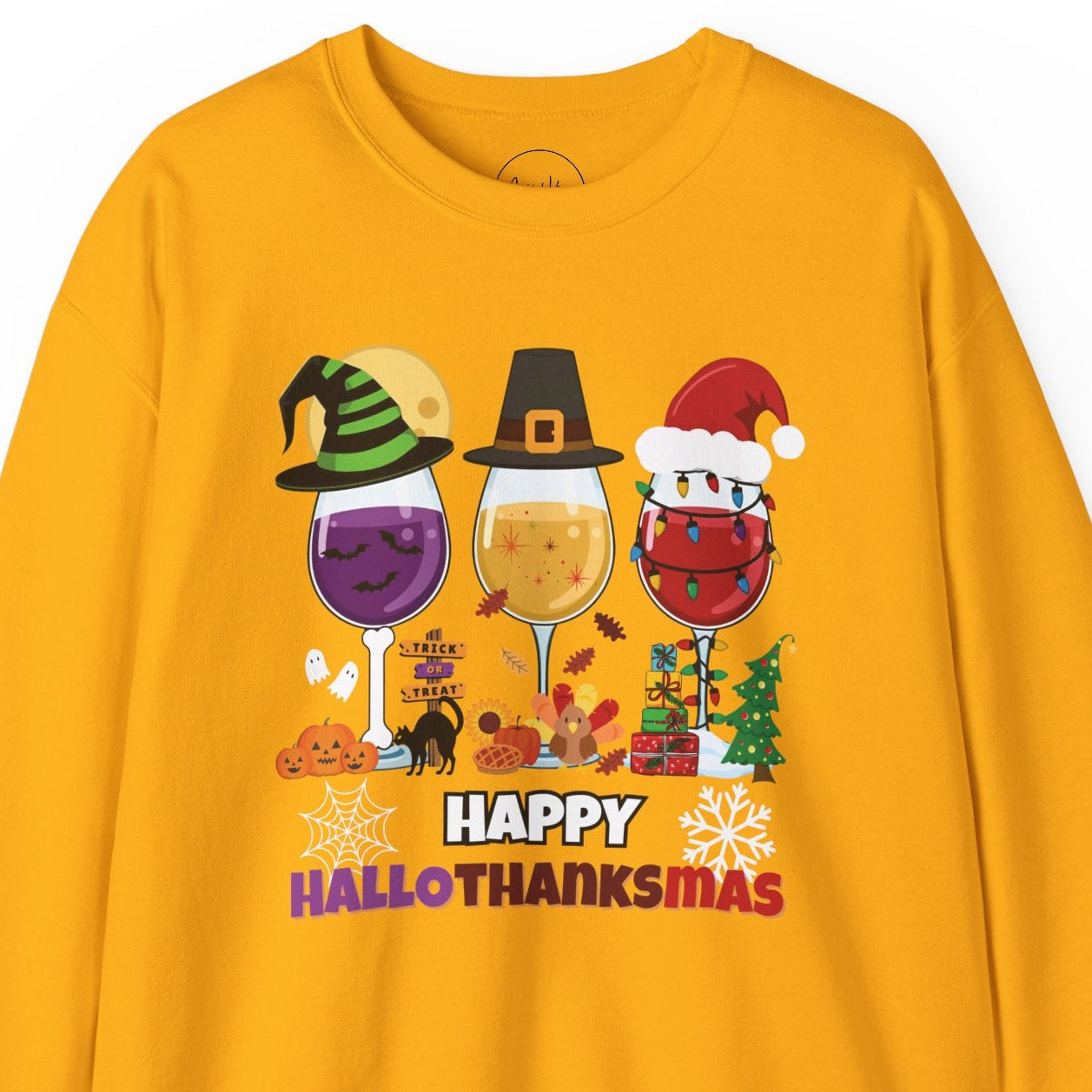 Yellow sweatshirt with 'Happy HalloThanksMas' design featuring wine glasses and holiday-themed graphics on a white background.