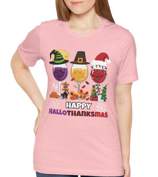 Person wearing a pink t-shirt with 'Happy HalloTHANKsmas' design on a white background