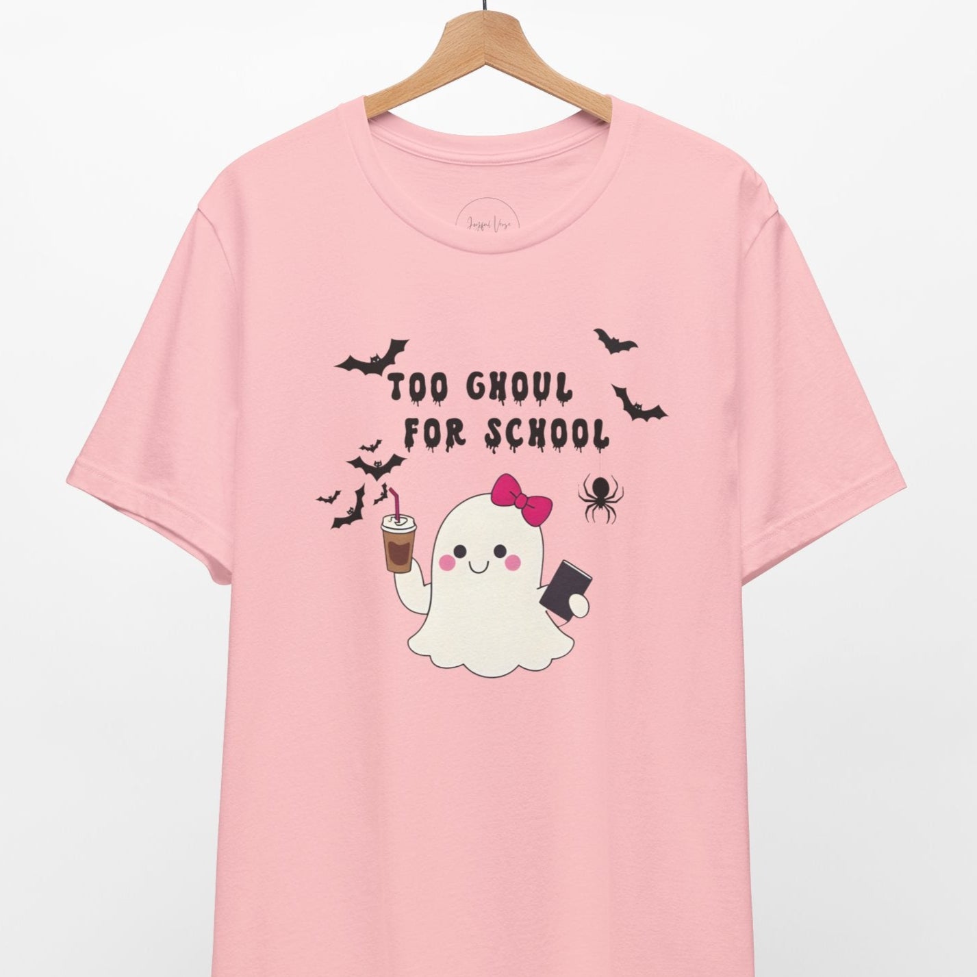 Pink t-shirt with ghost graphic and text 'Too Ghoul for School' on a hanger.