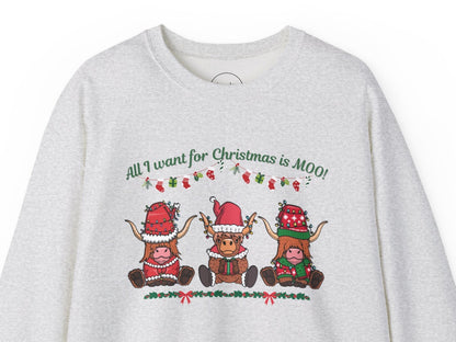 Grey sweatshirt featuring "All I Want for Christmas Is MOO" sweatshirt featuring three festive cows wearing Santa hats and scarves, printed on cozy crewneck sweaters in white and pink. Exclusive Joyful Verse design by Sara.