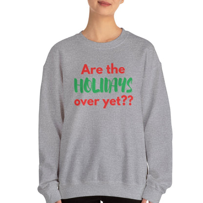 Person wearing a gray sweatshirt with the words "Are the holidays over yet??" on a white background