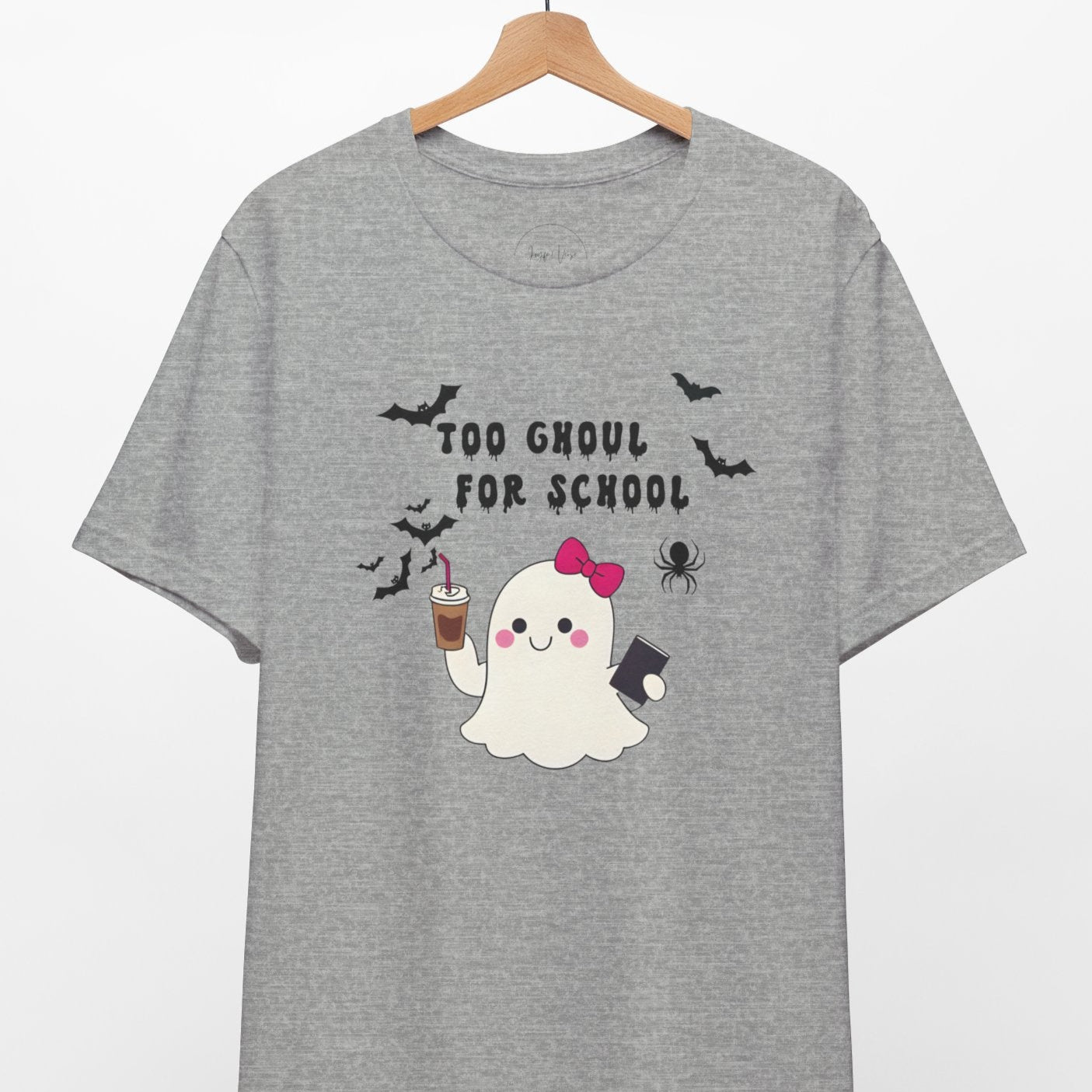 Gray t-shirt with a ghost design and text 'Too Ghoul for School' on a hanger against a white background