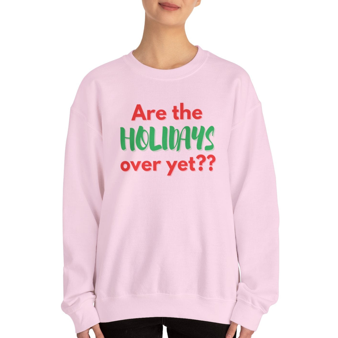 Person wearing a pink sweatshirt with text 'Are the holidays over yet??' on a white background