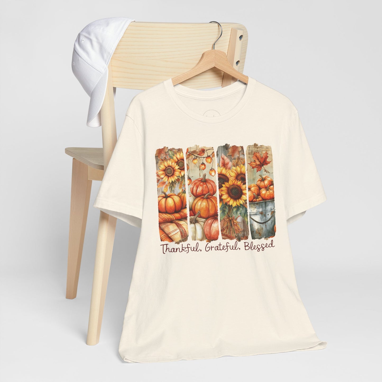 Beige t-shirt with autumn-themed design and text on a white background