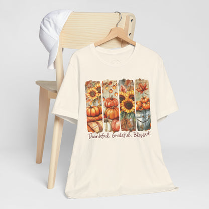Beige t-shirt with autumn-themed design and text on a white background