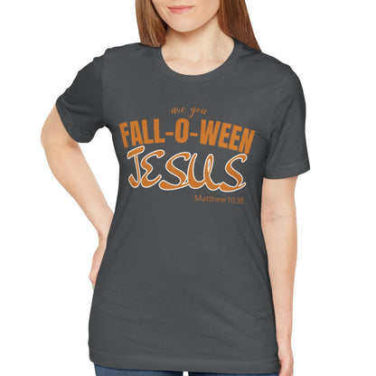 Woman wearing a dark gray t-shirt with 'Fall-o-Ween Jesus' text on a white background