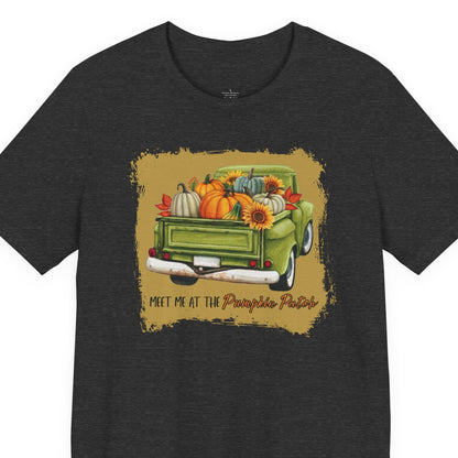 Black t-shirt with a graphic of a green truck carrying pumpkins and fall decorations on a white background.