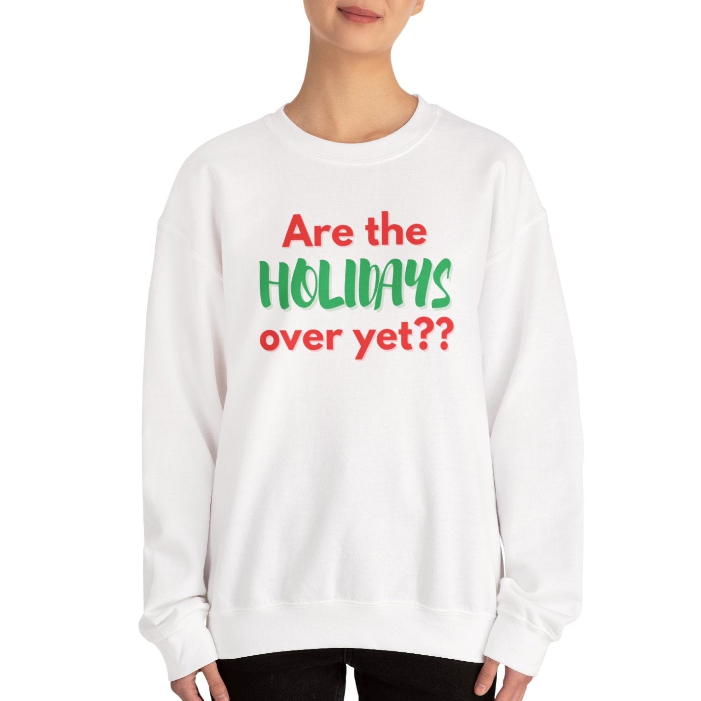 Person wearing a white sweatshirt with text 'Are the holidays over yet??' on a white background