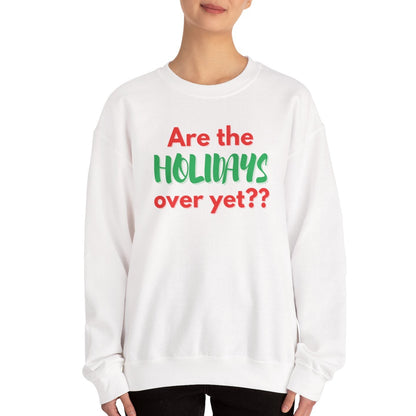 Person wearing a white sweatshirt with text 'Are the holidays over yet??' on a white background