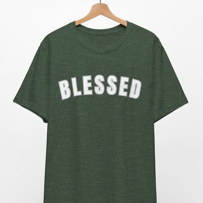 Green t-shirt with 'BLESSED' text on a hanger against a white background