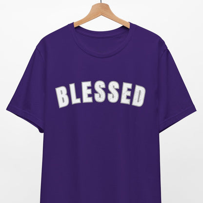 Purple t-shirt with 'BLESSED' text on a hanger against a white background