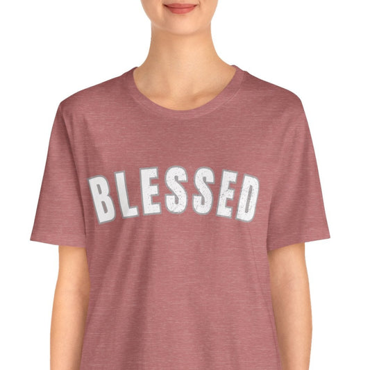 Person wearing a mauve t-shirt with 'BLESSED' text on a white background