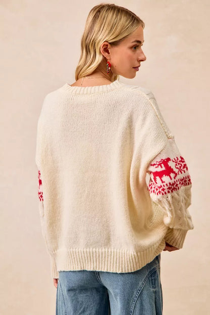 Christmas-themed cable knit sweater with festive red and white holiday pattern on a female model.